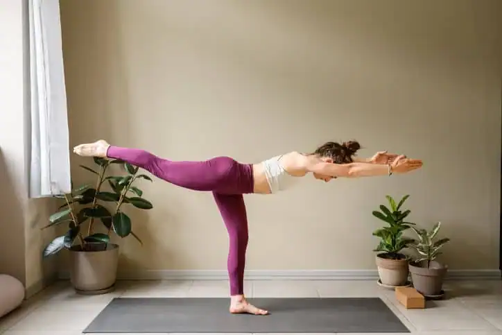 Woman doing Yoga exercise Essex to help with toning the body. 